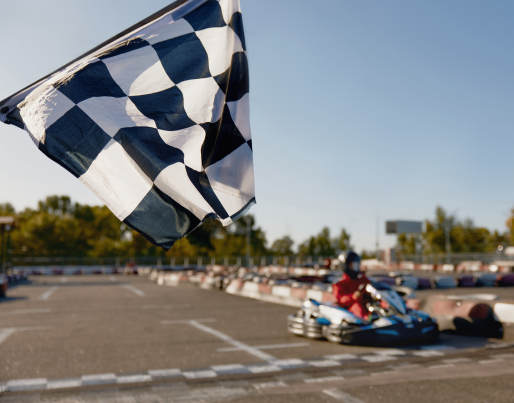 a group of people are riding go karts on a track .