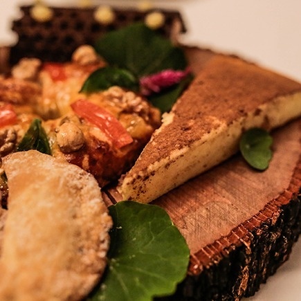 a slice of pizza is on a wooden cutting board