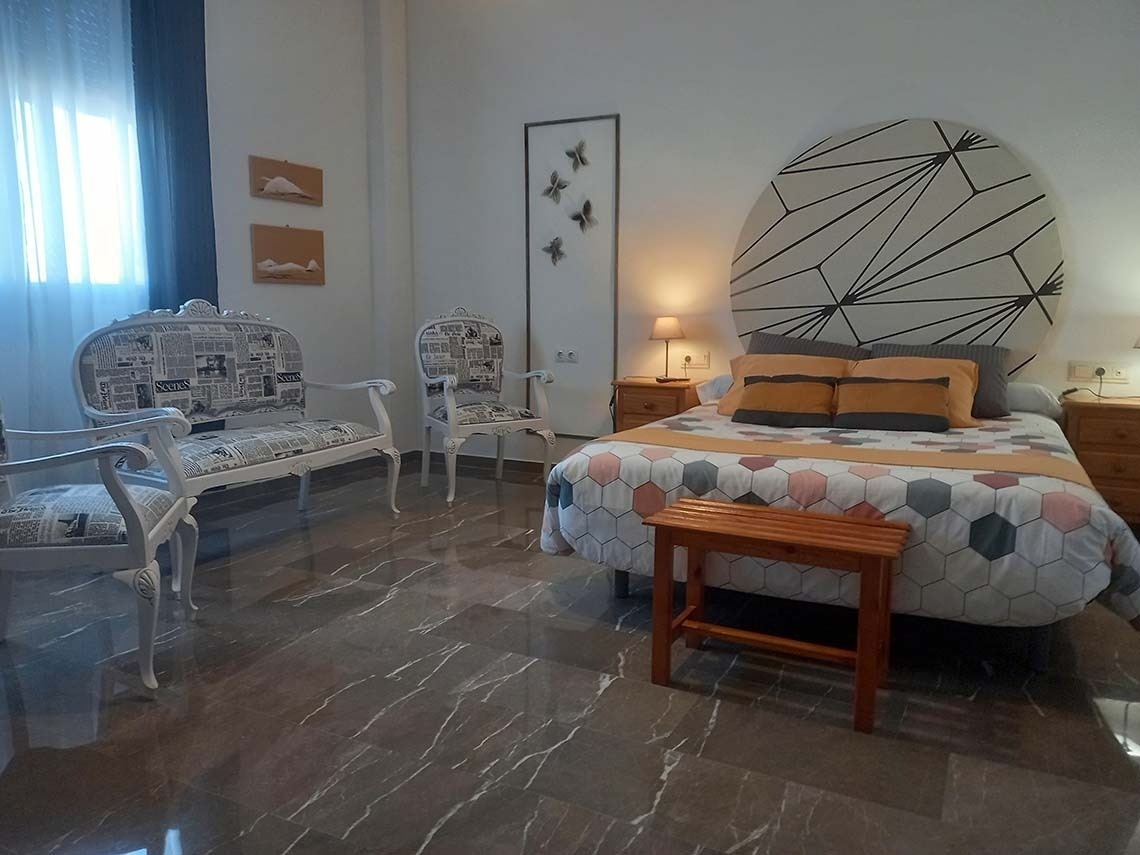 two beds in a bedroom with blue and white stripes on the wall