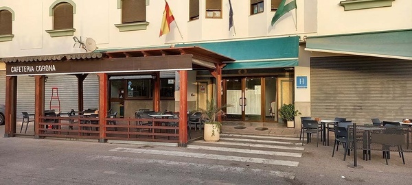 a restaurant called cafeteria corona has tables and chairs outside