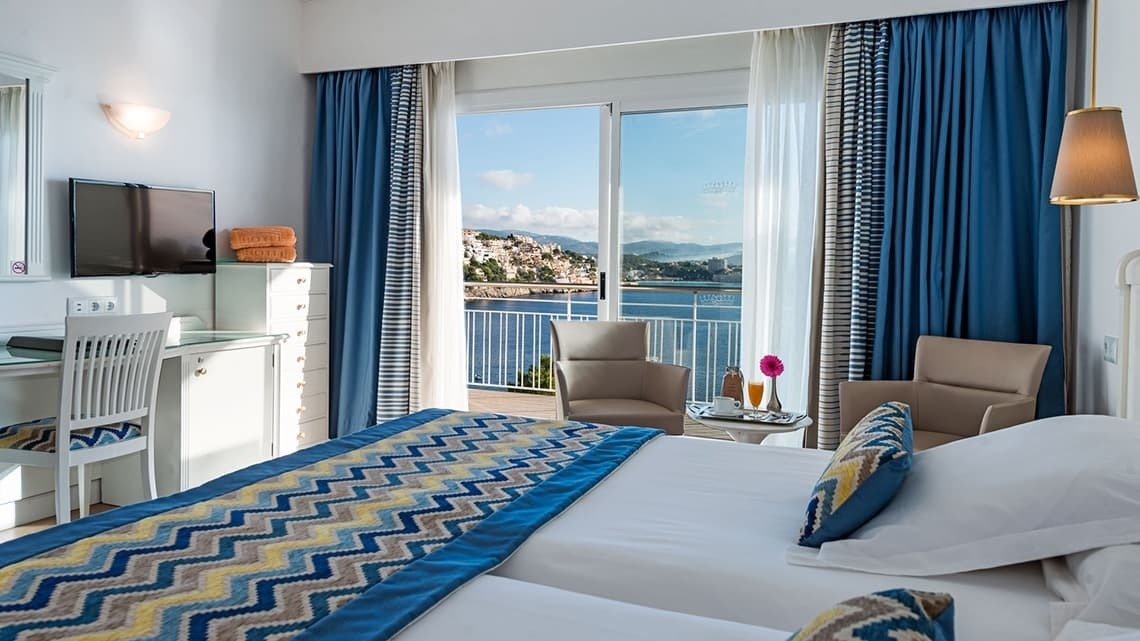 a hotel room with a view of the ocean