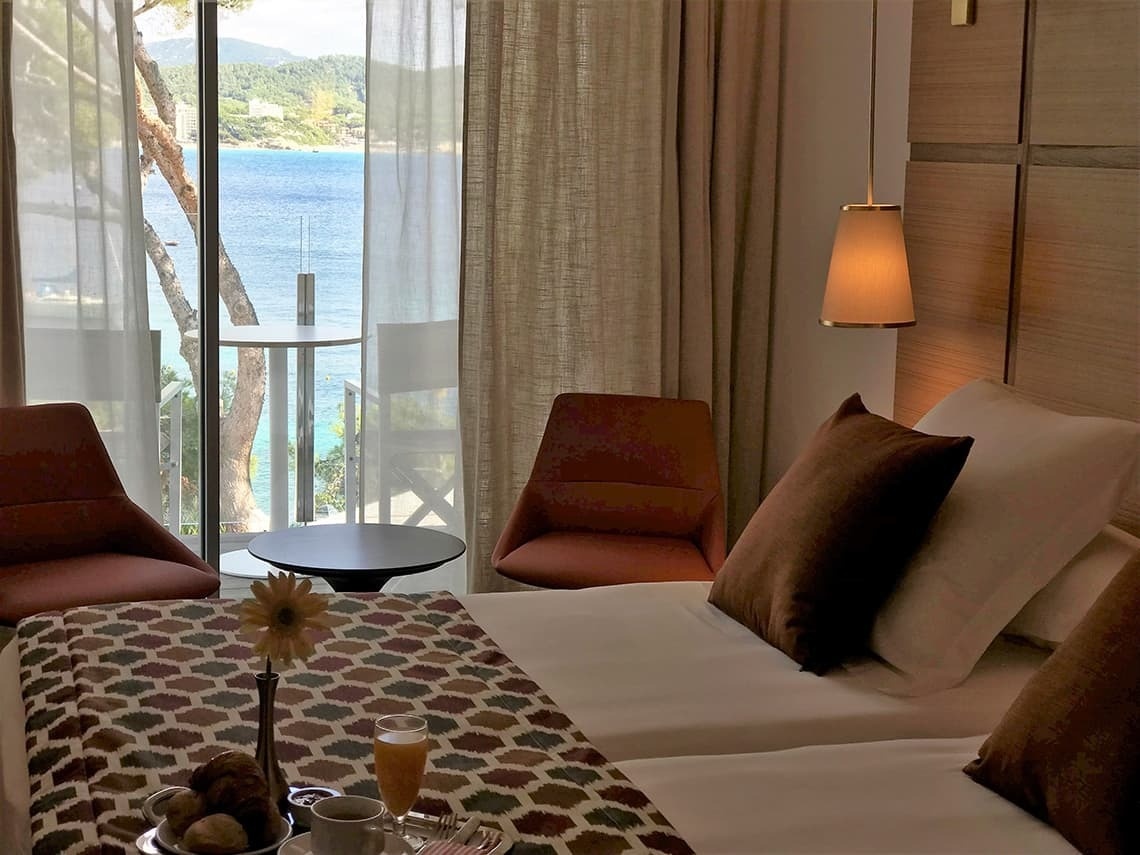 a hotel room with a view of the ocean