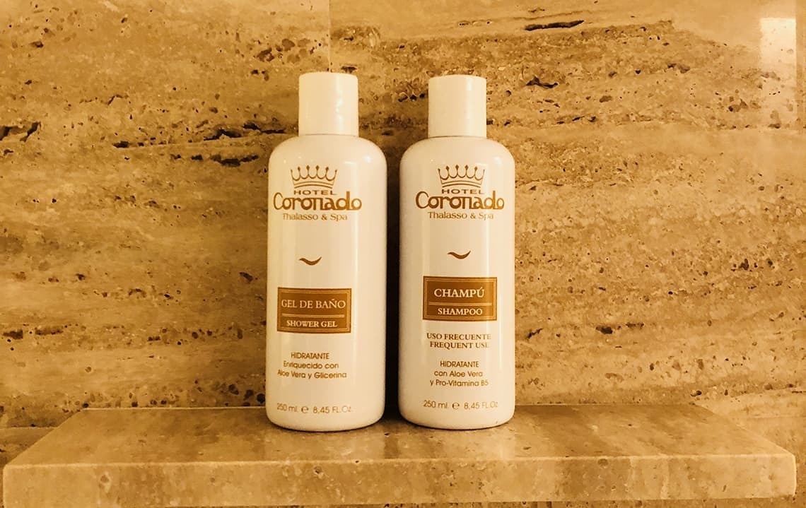 two bottles of coronado shampoo and shower gel on a shelf