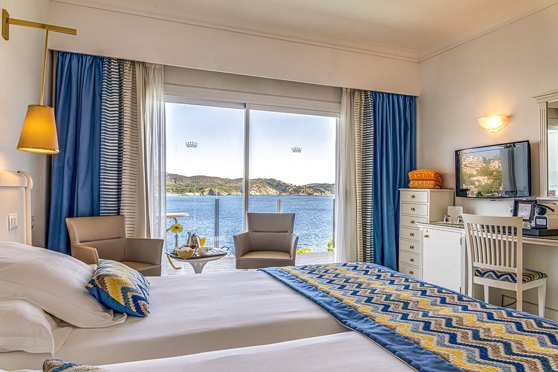 a hotel room with a view of the ocean