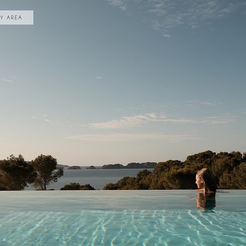 Eine Frau schwimmt in einem Infinity-Pool mit einem Zeichen darüber, dass es nur für Erwachsene ist