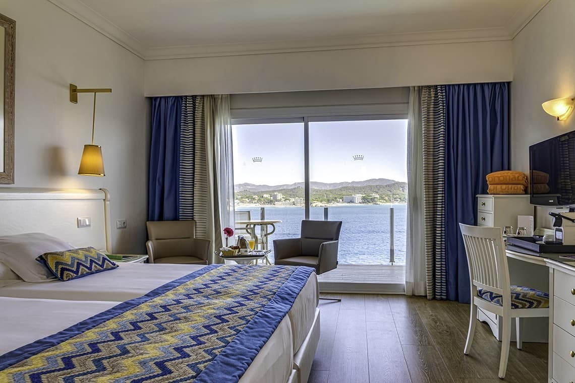 a hotel room with a view of the ocean