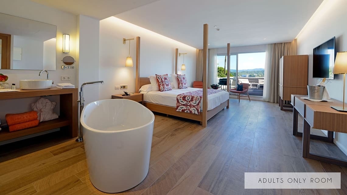 a hotel room with a bathtub and a sign that says adults only room