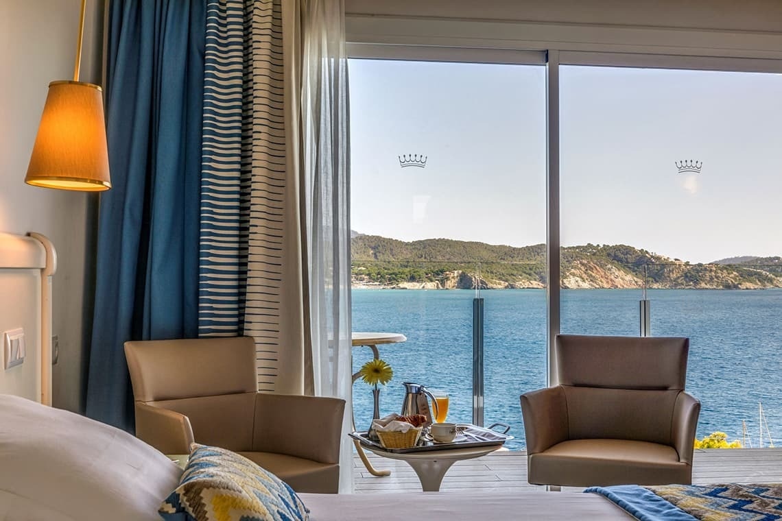a hotel room with a view of the ocean