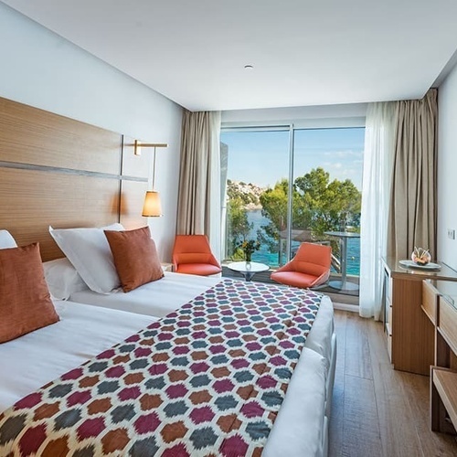 ein Hotelzimmer mit zwei Betten und einem Fernseher