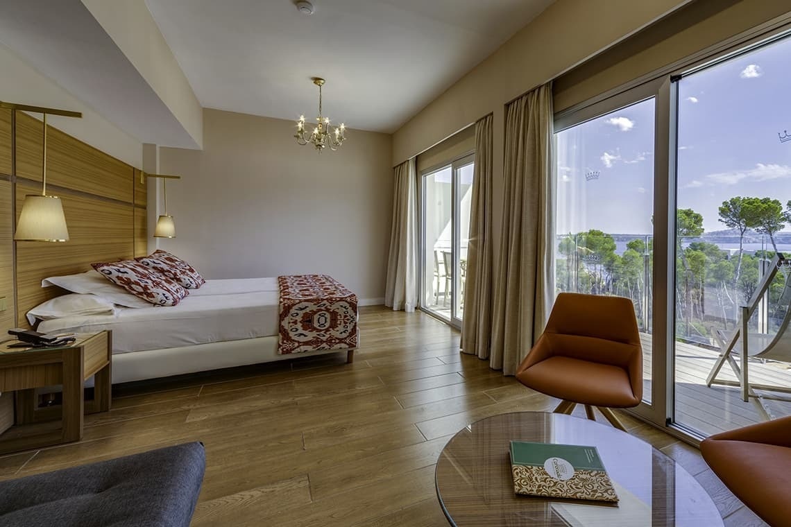 a hotel room with a large bed and a sliding glass door
