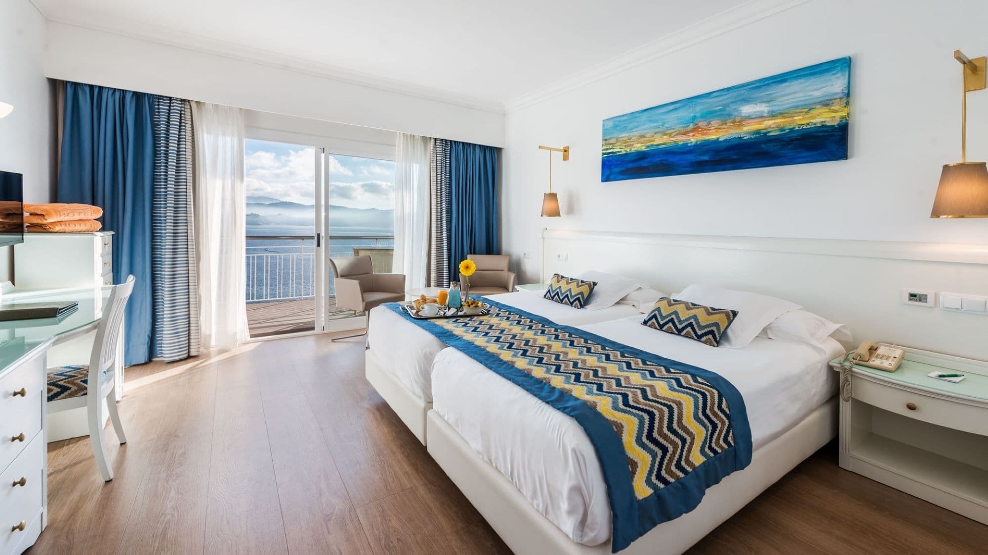 a hotel room with two beds and a painting on the wall