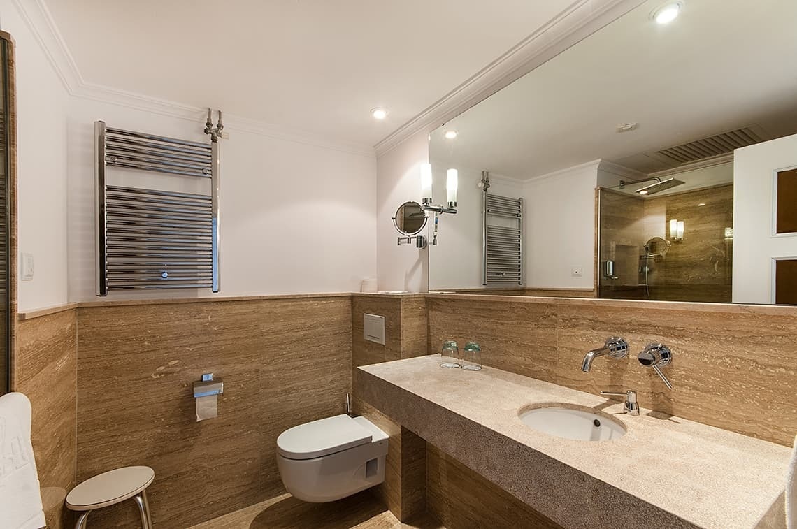 a bathroom with a toilet a sink and a mirror