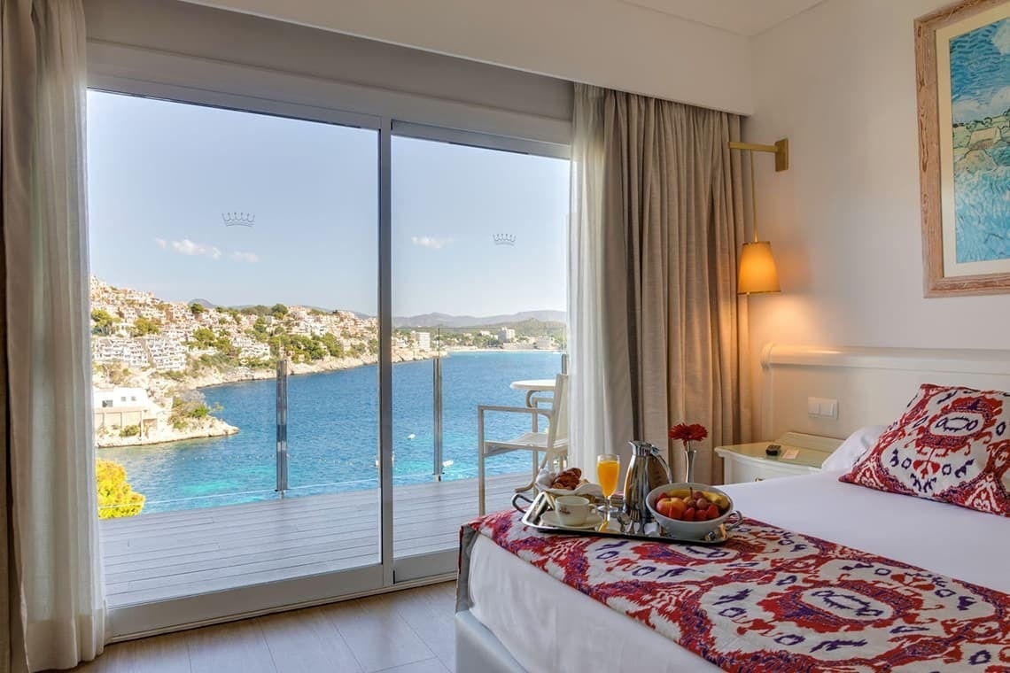 a hotel room with a view of the ocean