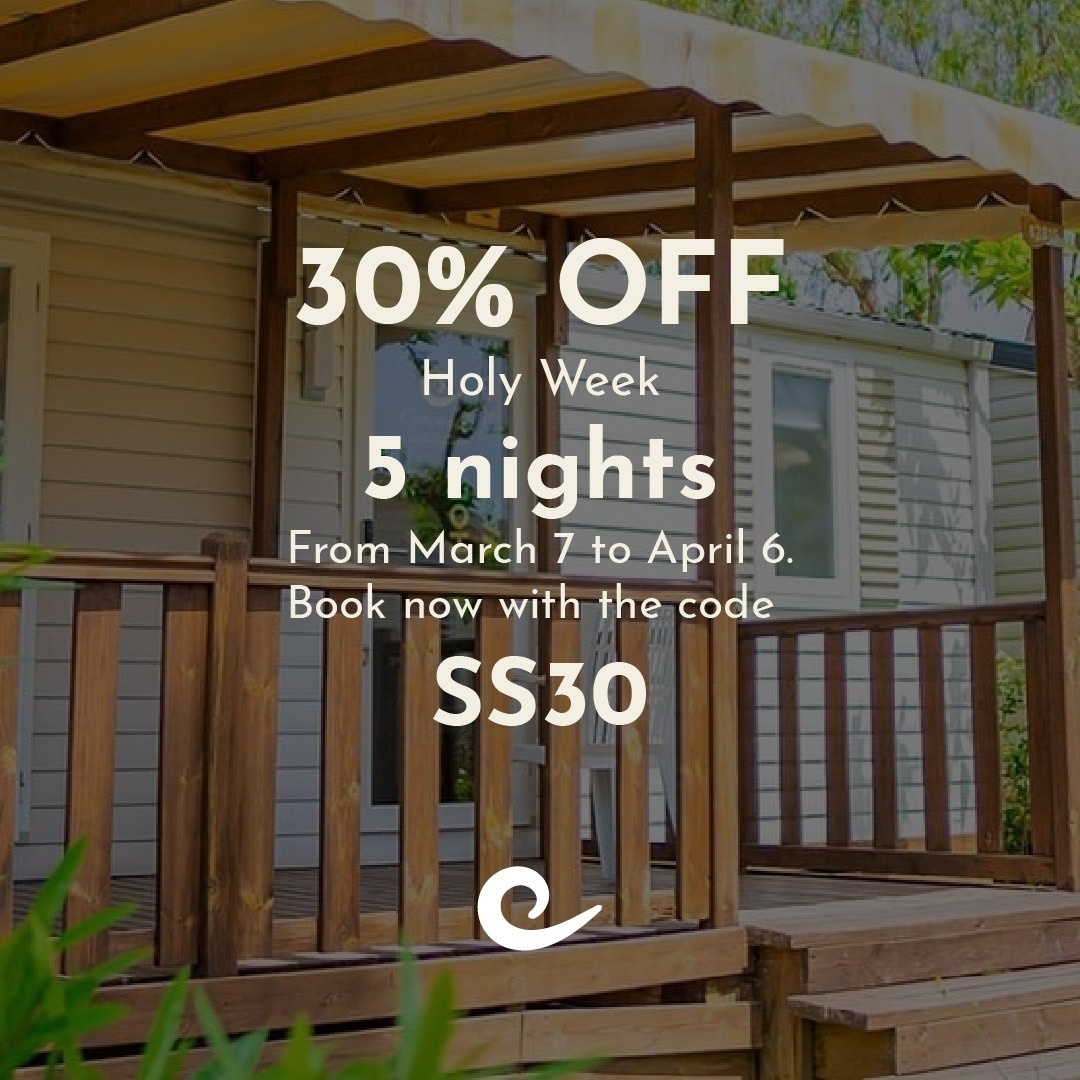a family walks along the beach holding hands
