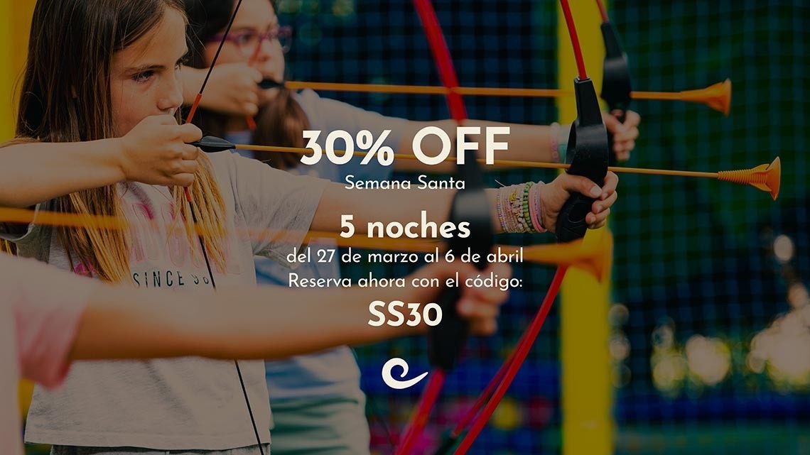 una familia se para en la playa al atardecer