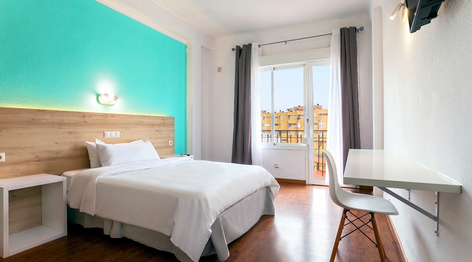 a hotel room with a bed and a desk