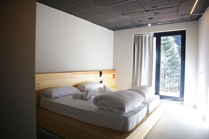una habitación con dos camas y una puerta de vidrio