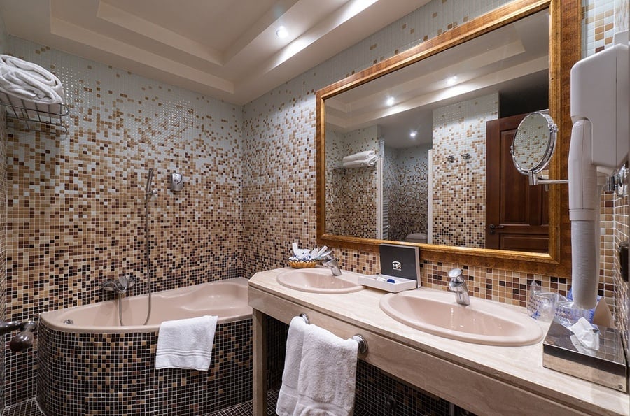 un baño con dos lavabos y un gran espejo