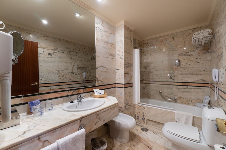 un baño con inodoro , lavabo y bañera
