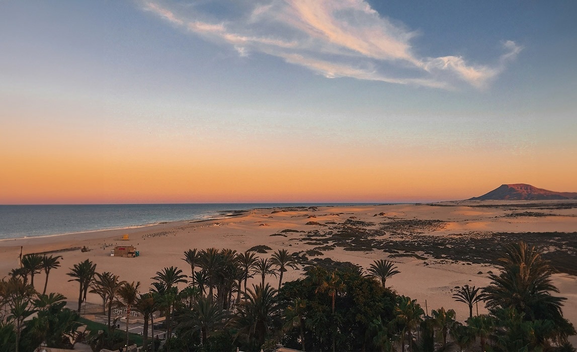 a snowy mountain range with a blue sky in the background