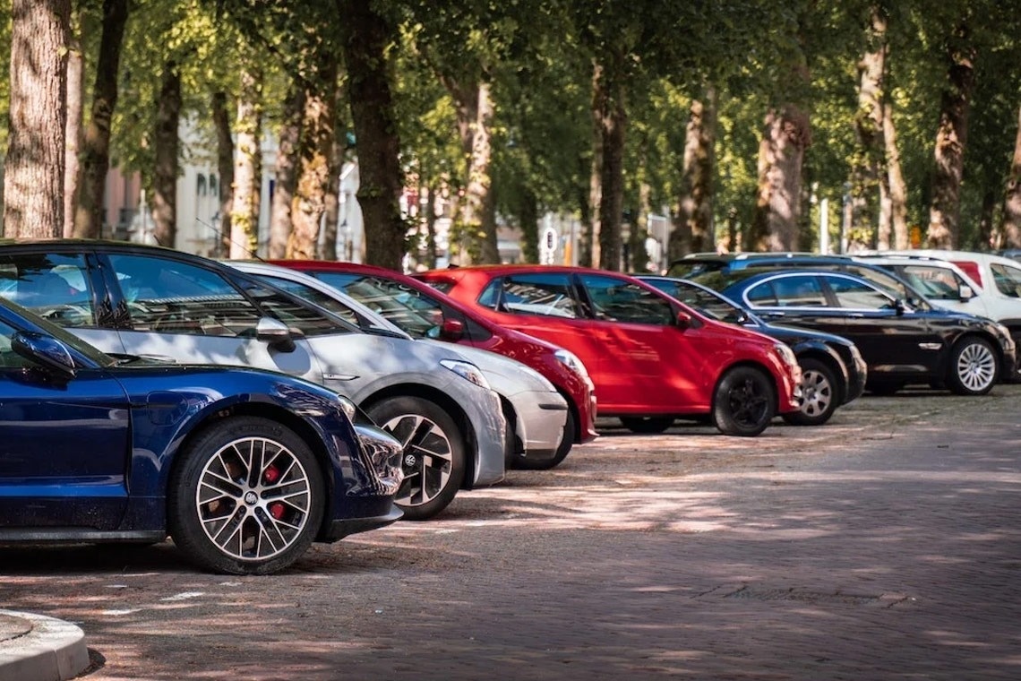 a glass of red liquid with a straw on the beach