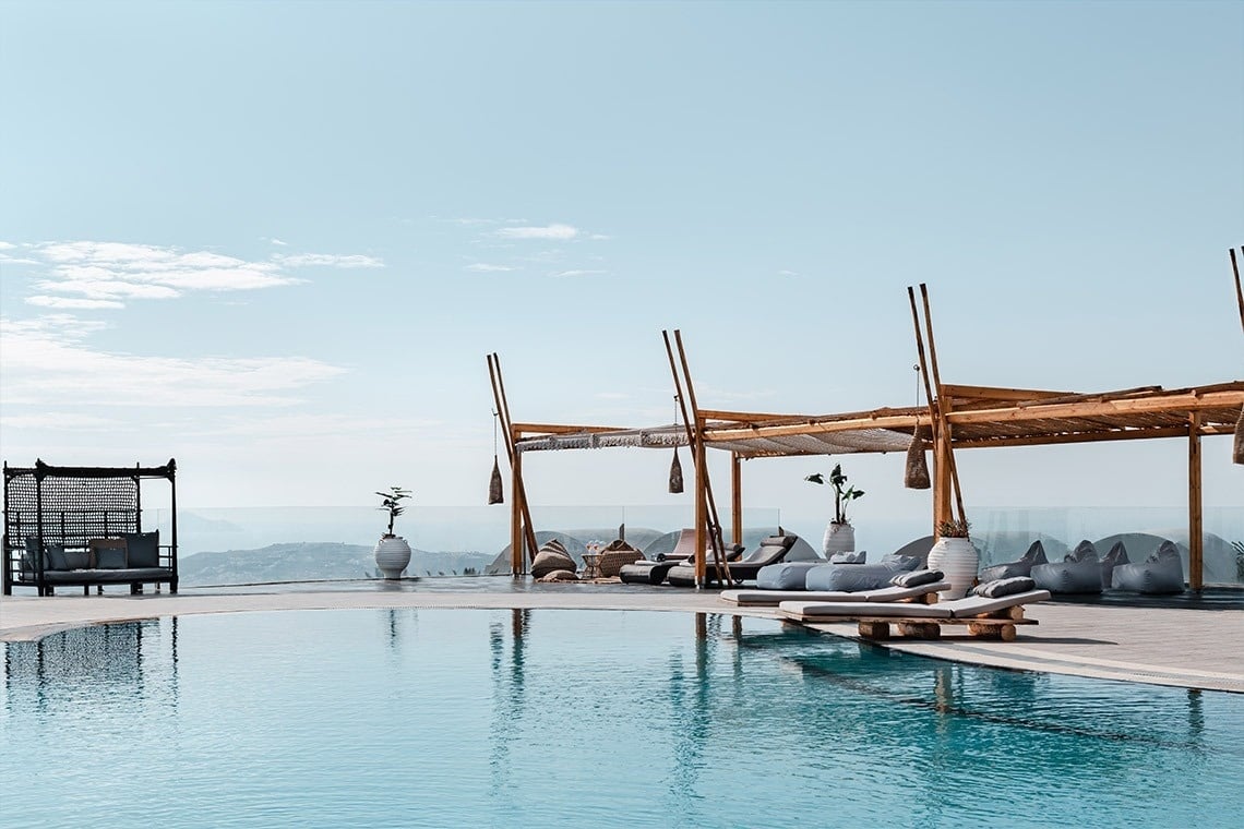una grande piscina circondata da sedie e un gazebo
