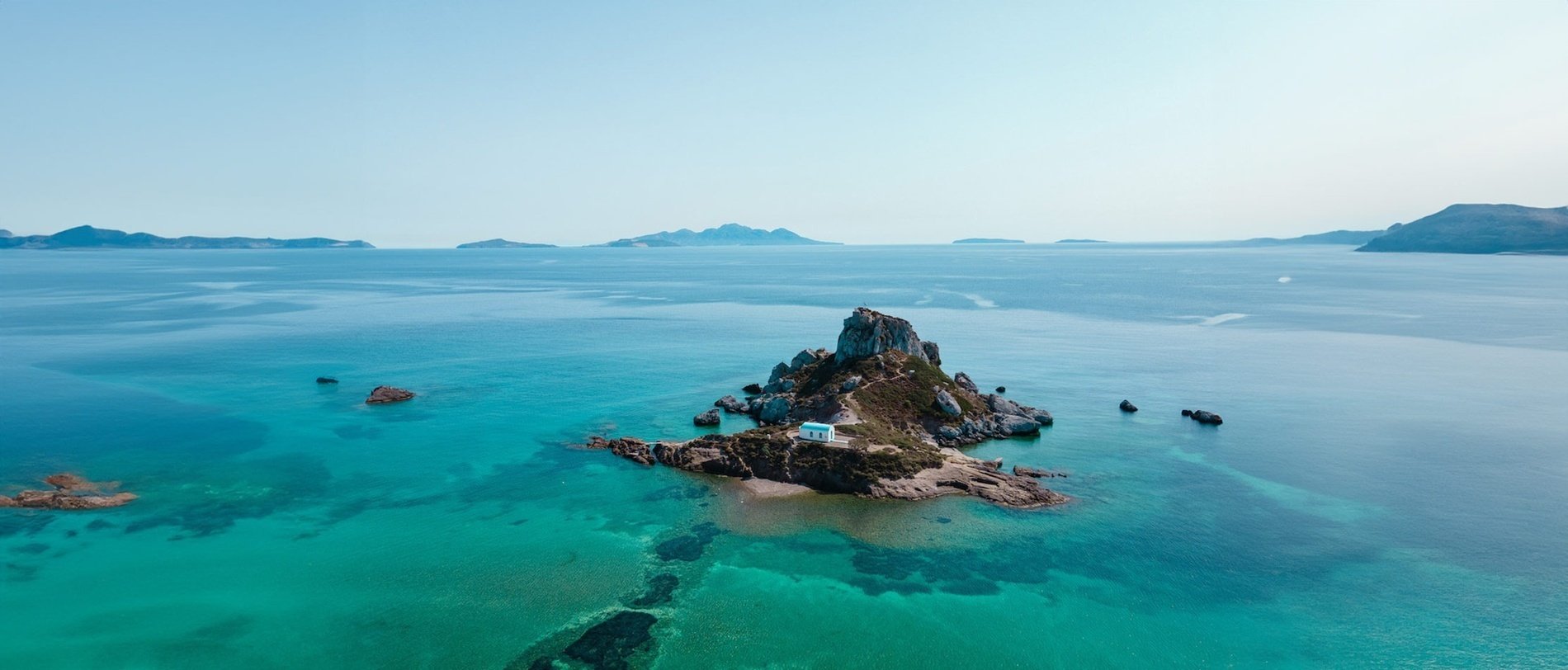 an aerial view of a sandy island in the middle of the ocean