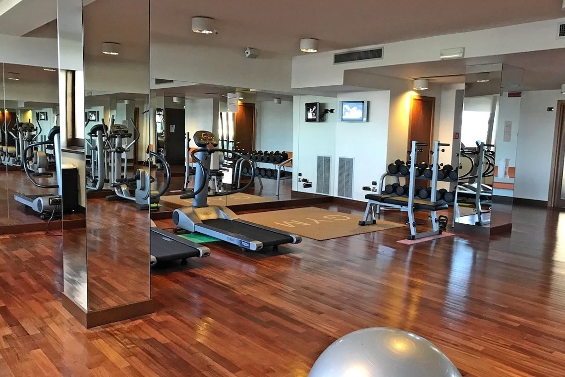 a glass of red liquid with a straw on the beach