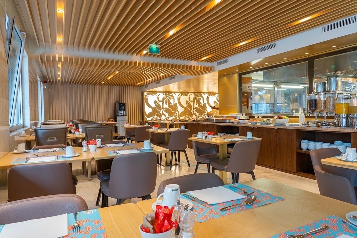 a restaurant with tables and chairs and a sign that says ' buffet ' on it