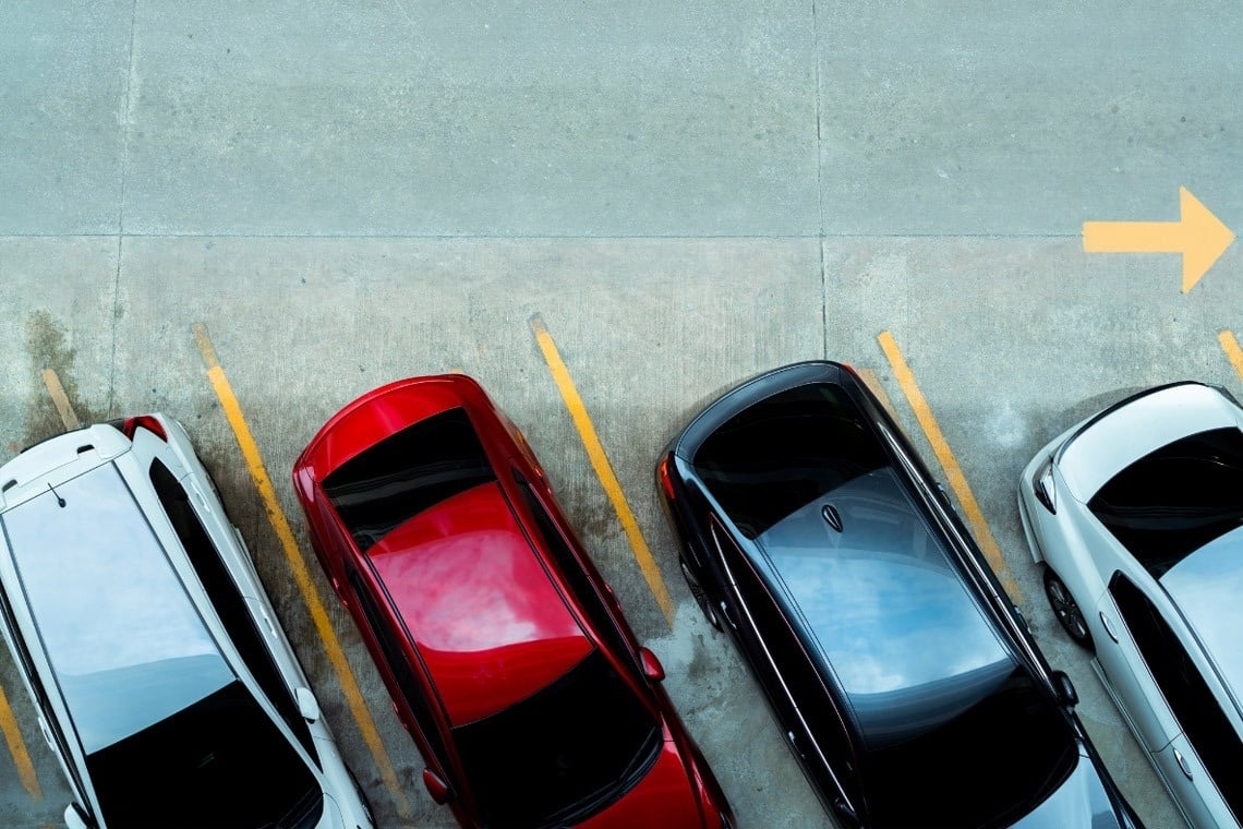 a glass of red liquid with a straw on the beach
