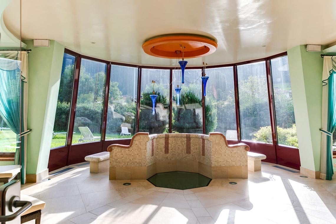 rows of tables and chairs in front of a screen that says smv hotels