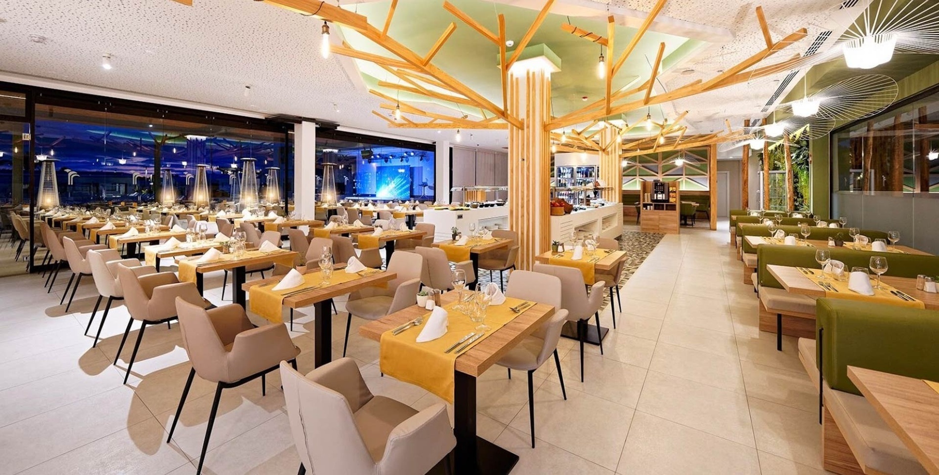a restaurant with tables and chairs and a tree in the ceiling
