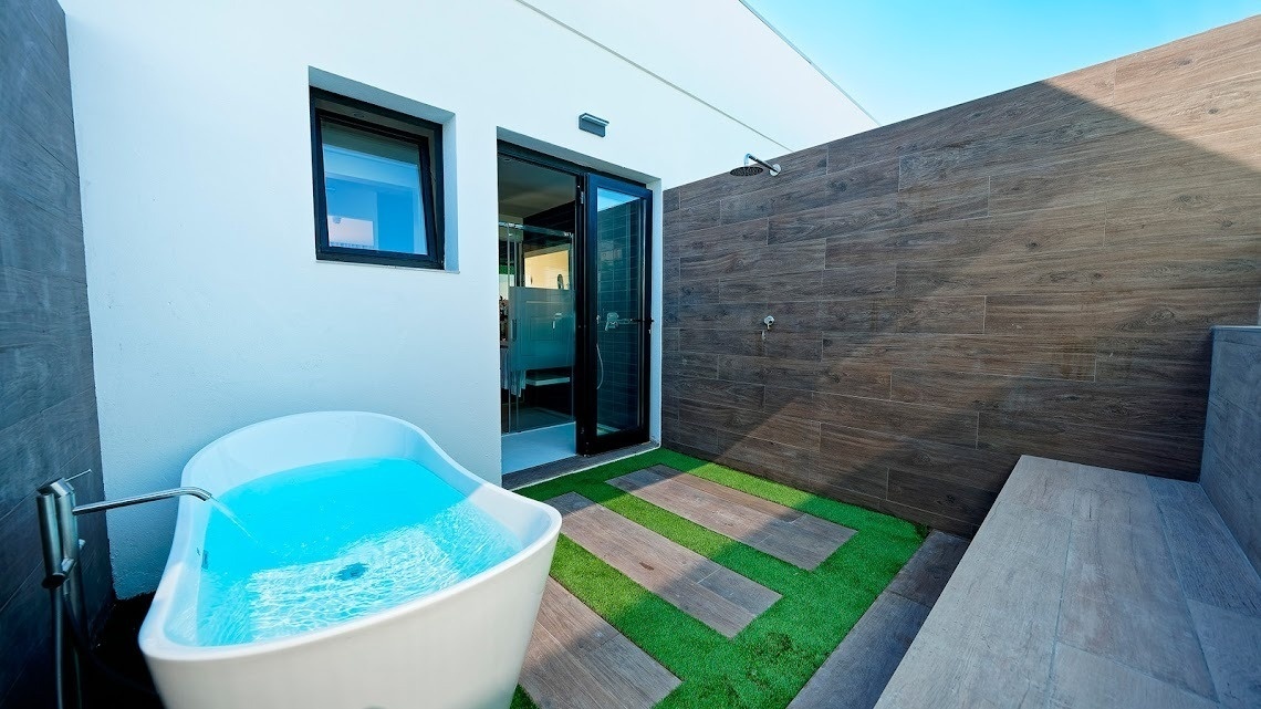 a bathroom with a bathtub and a walk in shower