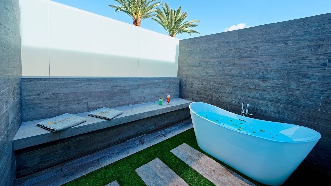 a bathtub in a bathroom with a towel that says ' spa ' on it