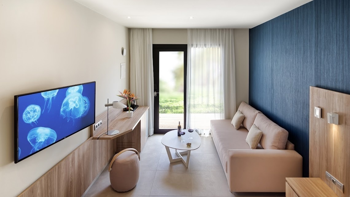 a living room with a couch and a television with jellyfish on it