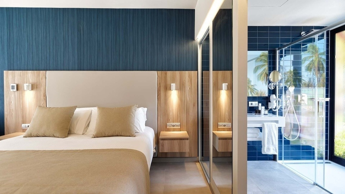 a hotel room with a bed and a bathroom