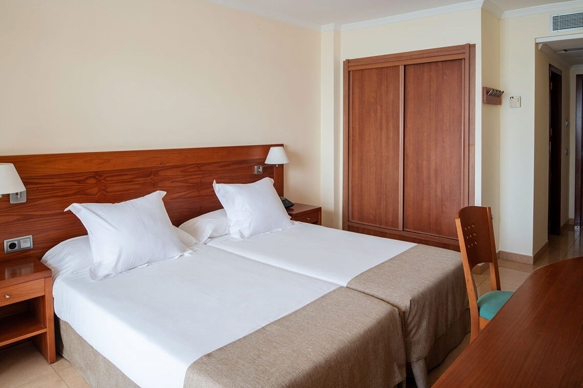 a hotel room with two beds and a closet