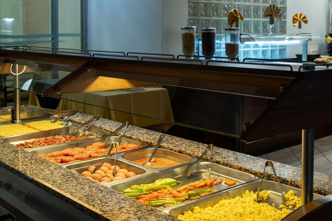 a buffet with a variety of food including eggs and rice
