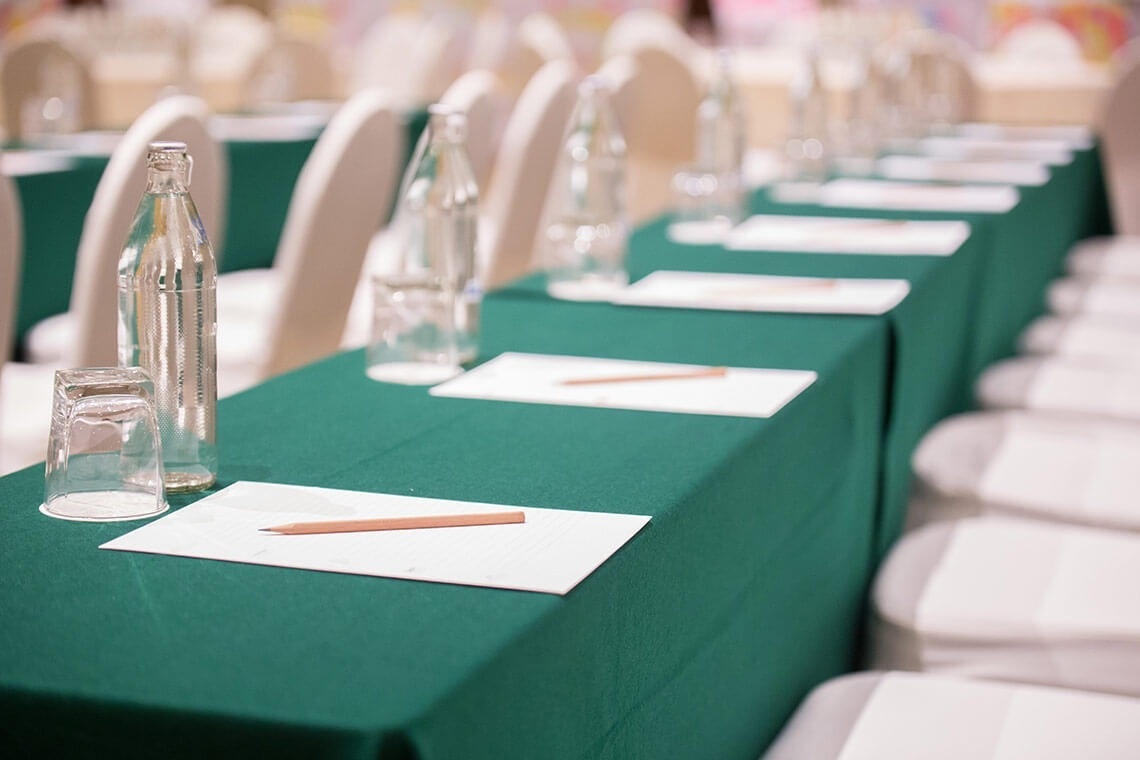 a bottle of water sits on a table with papers and a pencil