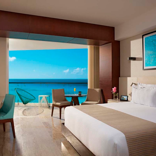 Luxury hotel room with ocean view balcony and king-size bed. DEMO 3