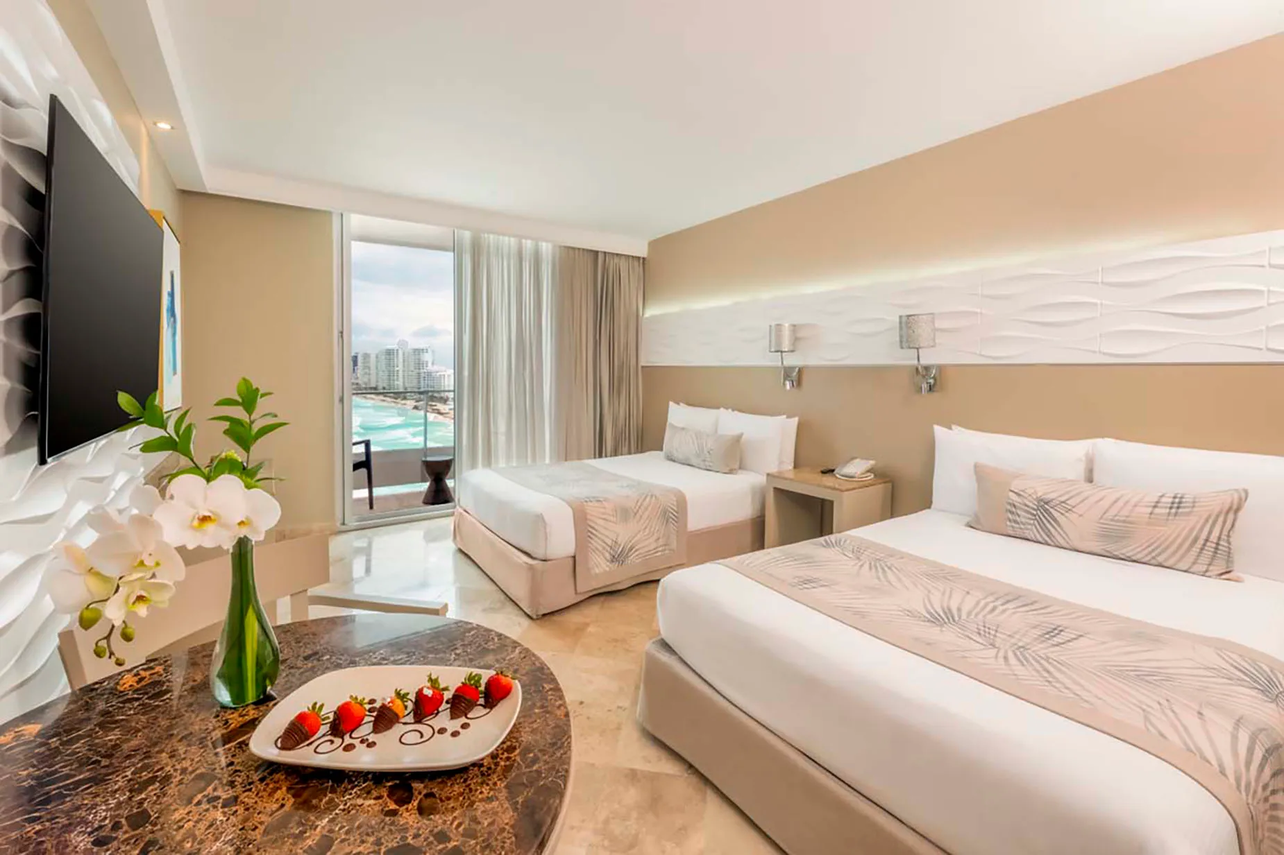 Hotel room with ocean view balcony, two beds, and welcome chocolate-dipped strawberries DEMO 3