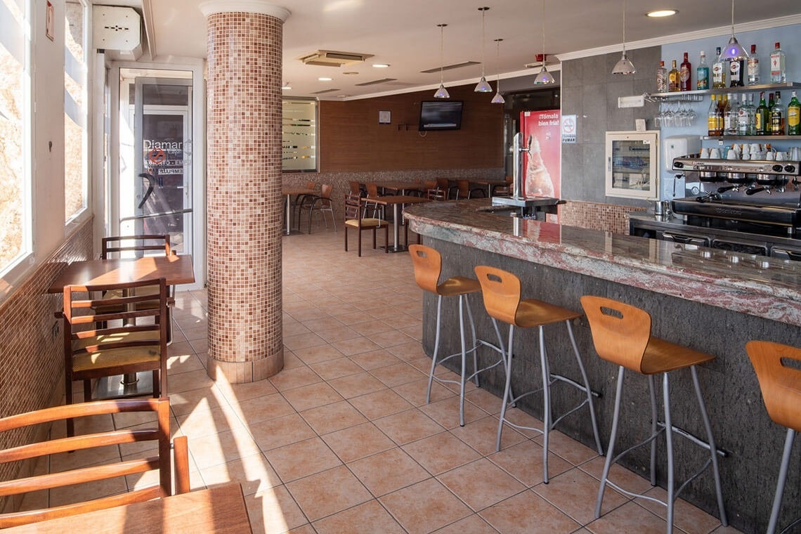 a restaurant with a coca cola fridge on the wall