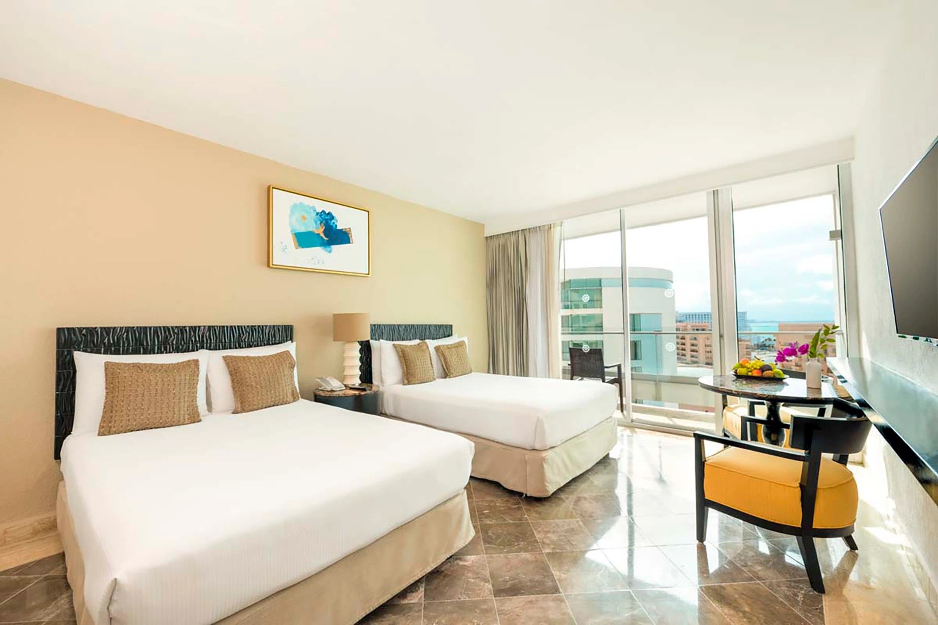 Hotel room with two beds, balcony view, and seating area. DEMO 3
