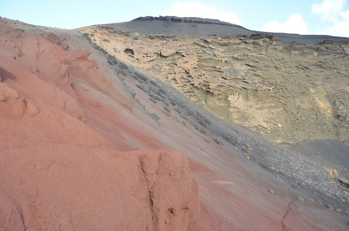 a rocky hillside with a mountain in the background