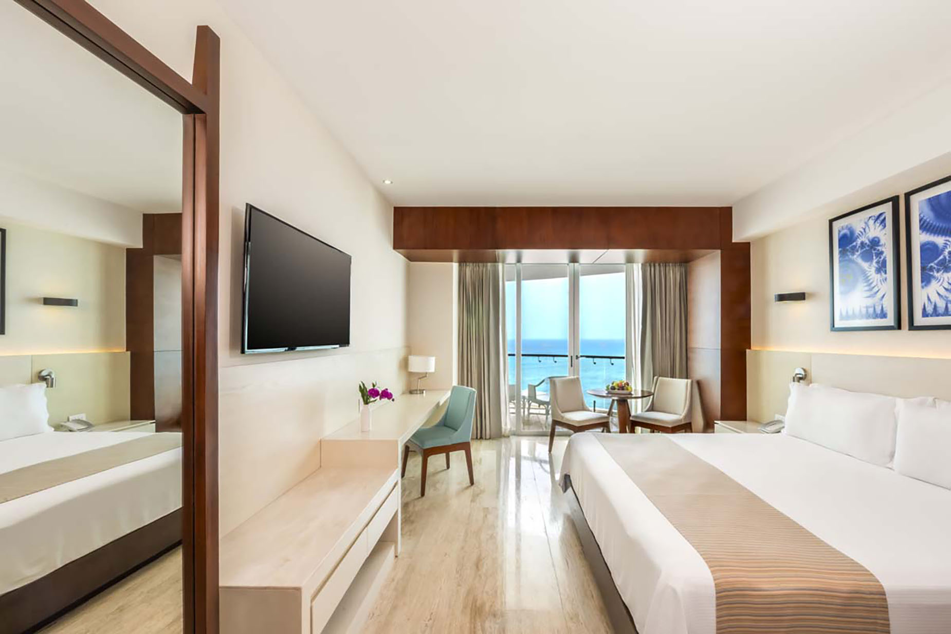 Luxury hotel room with ocean view, bed, desk, and balcony. DEMO 3