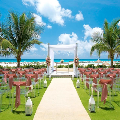 Beach wedding ceremony setup with chairs and DEMO 3 arch.
