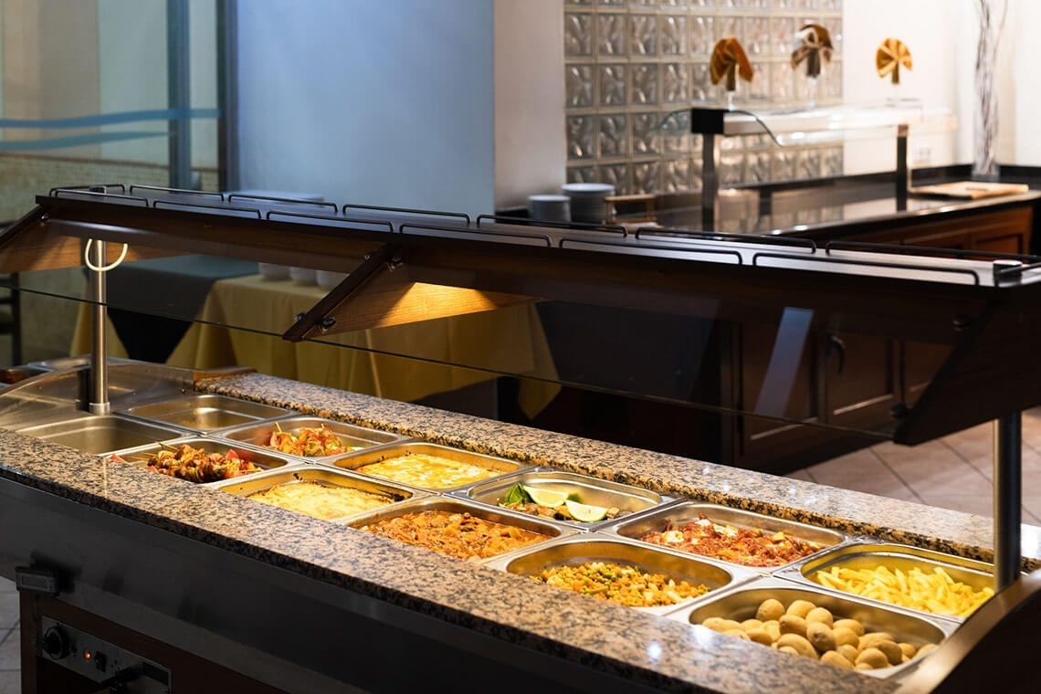 a buffet filled with a variety of food including french fries