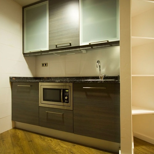 a small kitchen with a microwave and a sink