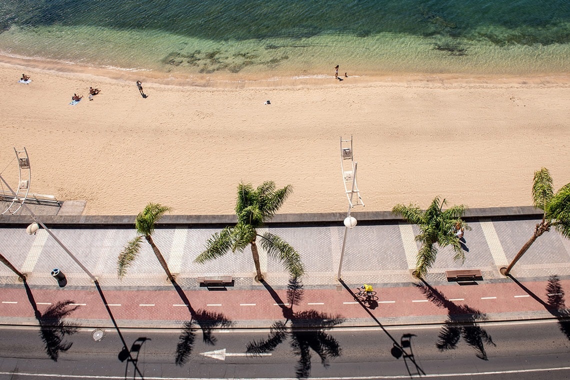 a hotel room with two beds a desk and a television