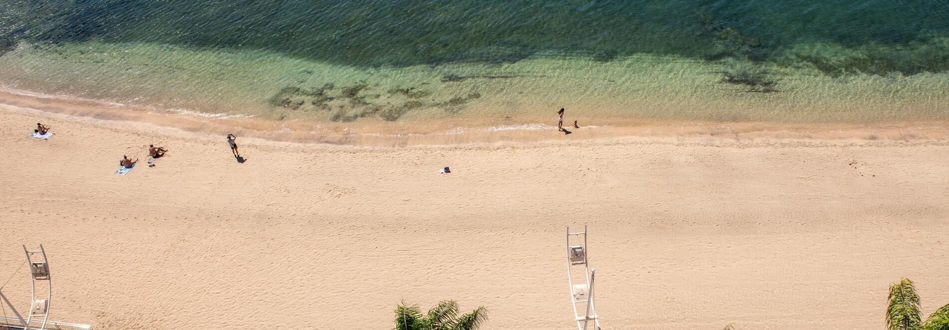 an aerial view of a beach with a lifeguard chair